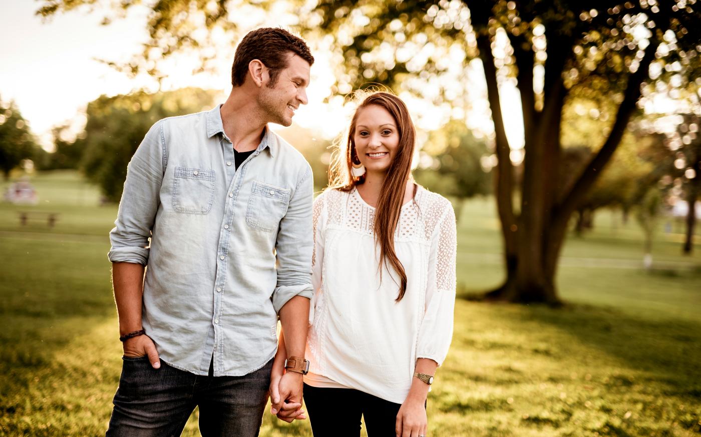 man holding hand of woman standing near tree by Ben White courtesy of Unsplash.